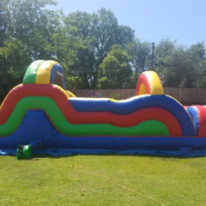 Colorful inflatable obstacle course on a sunny grassy field.
