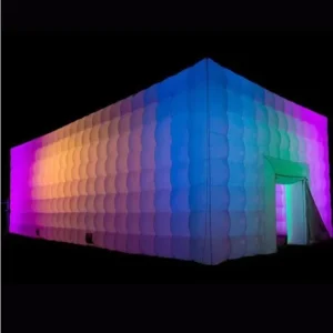 Illuminated colorful inflatable structure at night.