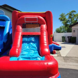 Inflatable red water slide in a sunny driveway.