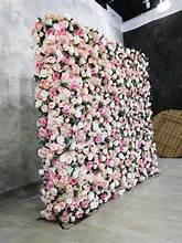 A large wall covered with pink and white flowers.